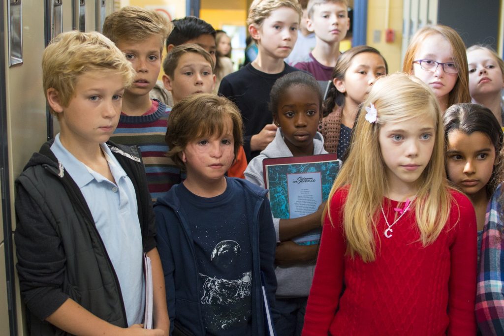 Jacob Tremblay as "Auggie" and Elle McKinnon as "Charlotte" in WONDER.